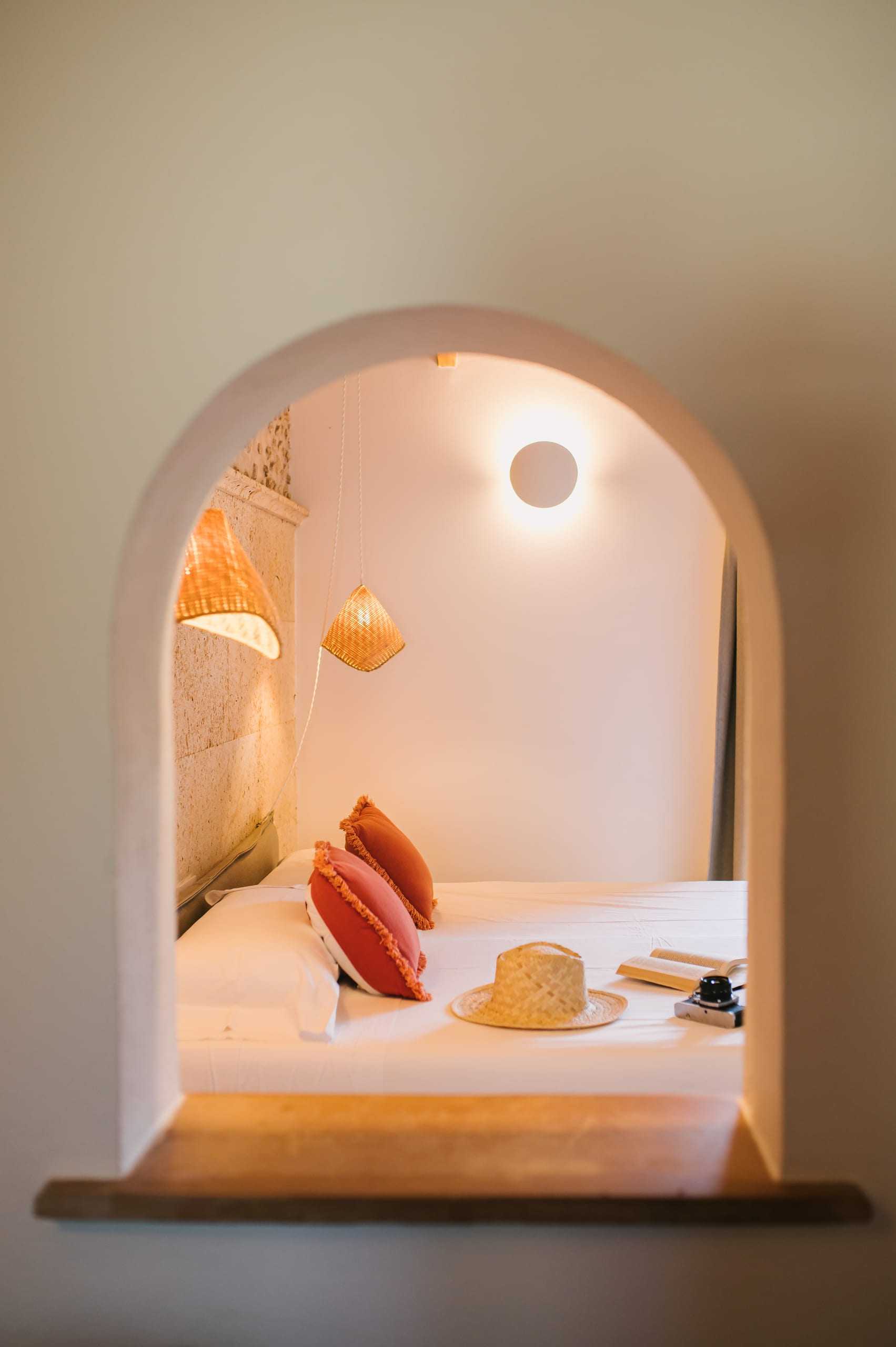 Bedroom seen through an arched opening