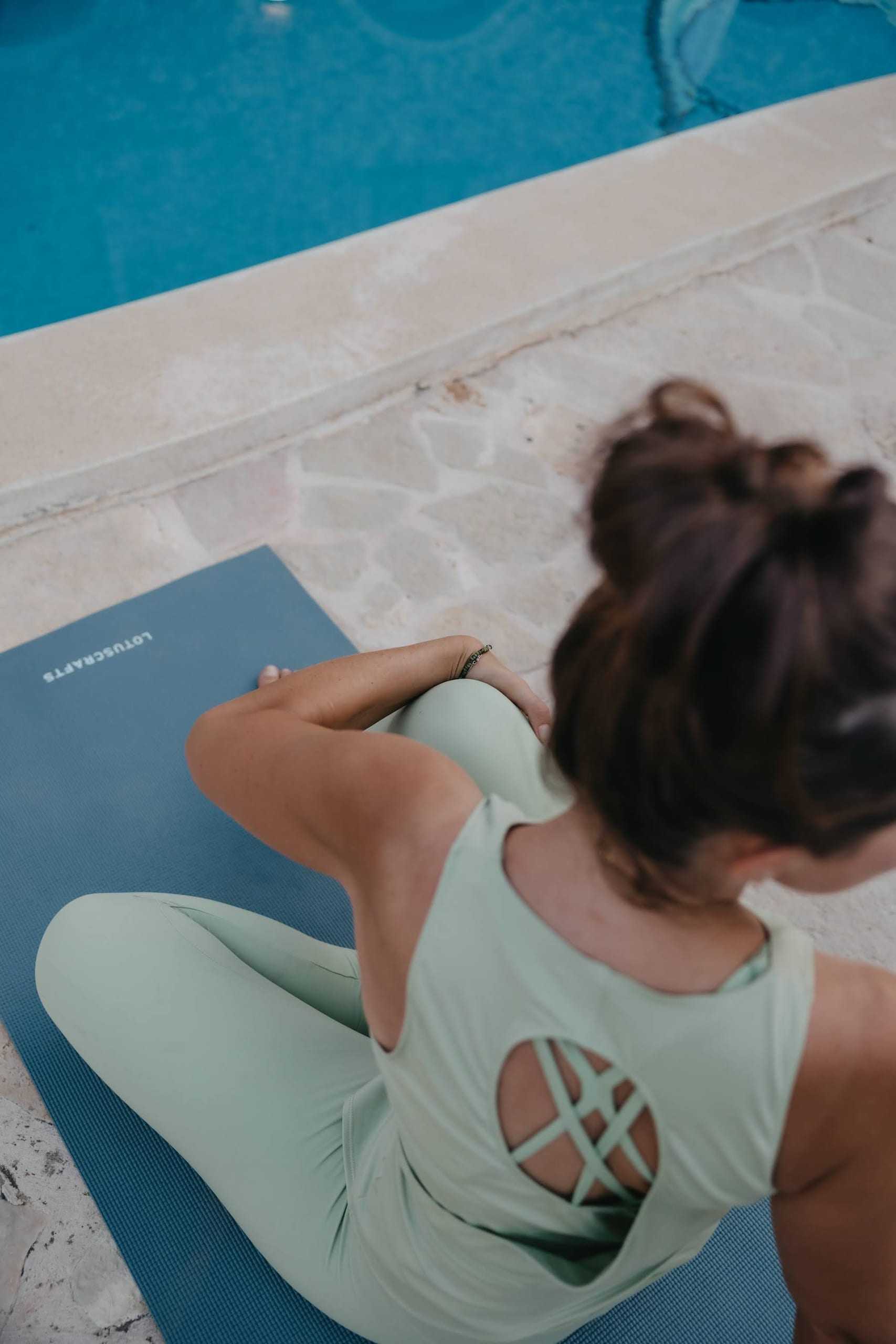 Stretching on a mat by the pool