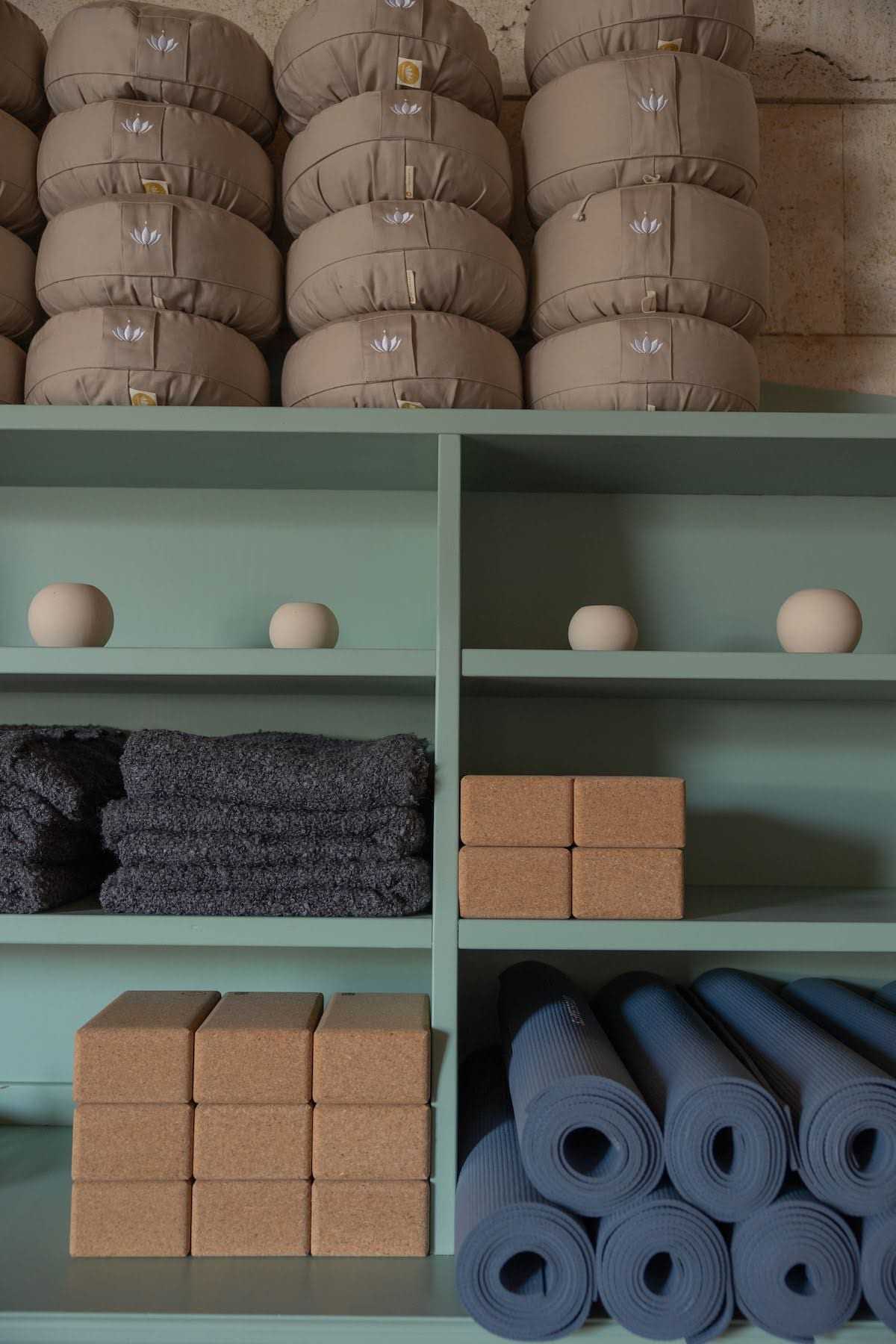 Shelves with meditation cushions, blocks and mats