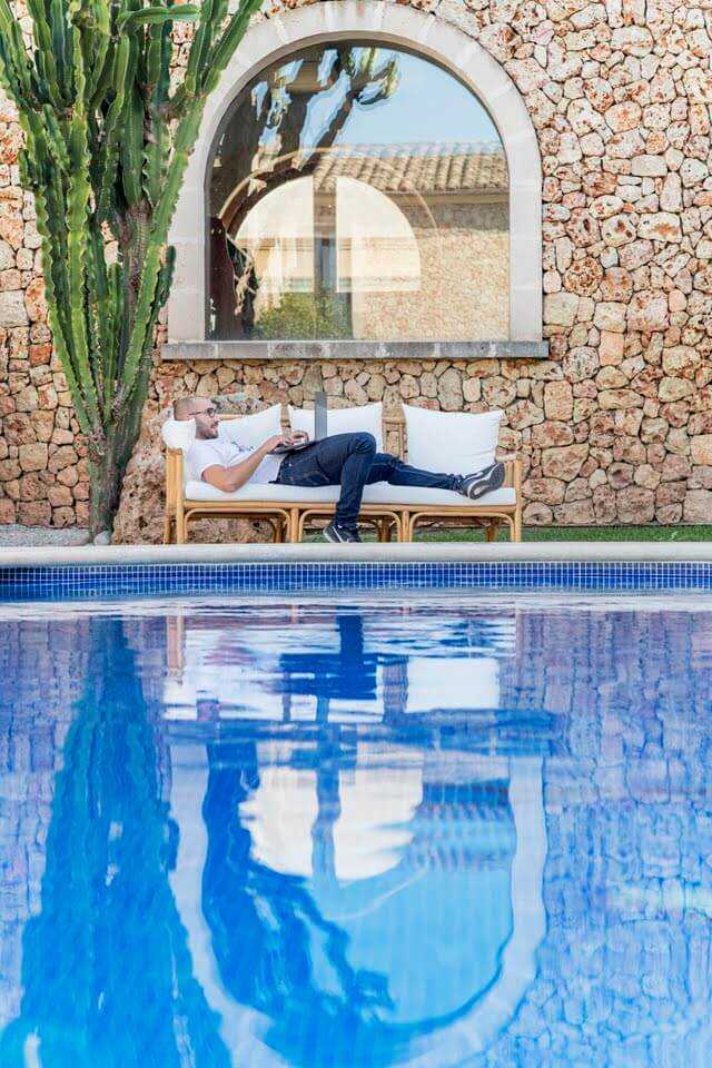 Pool reflecting an arched window of the house