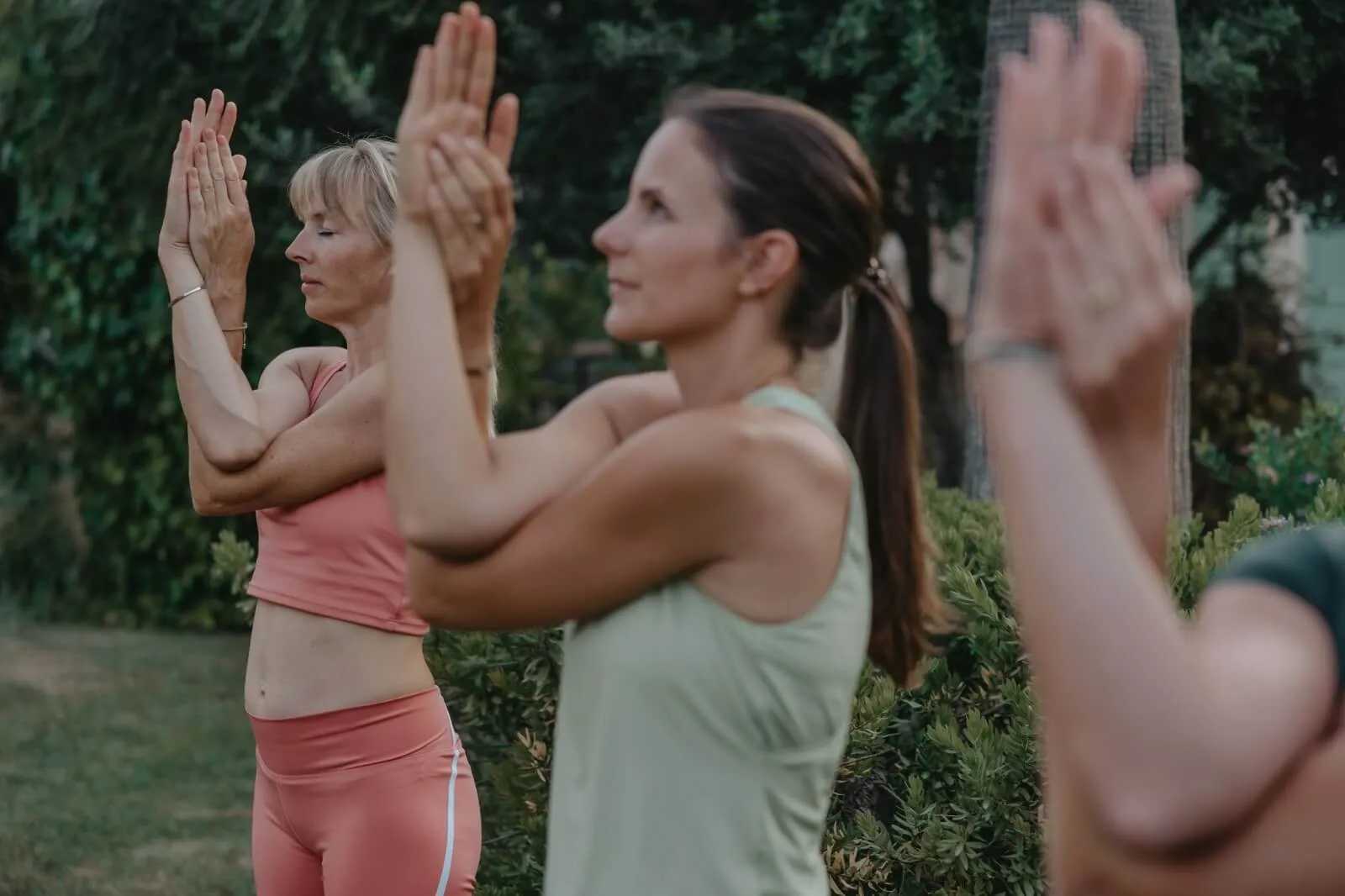 Women practising yoga in the garden